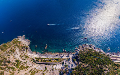Top down aerial view from distance, general view of the area Manarola and Riomaggiore. boats and rocky beach. Province of La Spezia, Liguria, Beautiful mountain north of Italy. Copy space background.