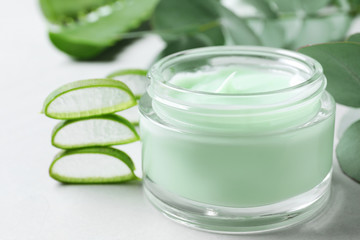 Jar of organic cream and aloe vera on light table