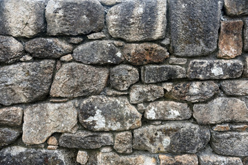 Texture of a stone wall. Old castle stone wall background. Wall made of wild stone. Natural background.