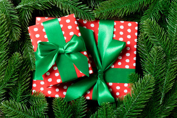 Top view of gifts box decorated with a frame made of fir tree on wooden background. New Year present time concept