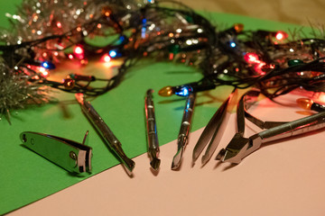 nail scissors file and clippers to remove the cuticle care products on a light background