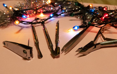 nail scissors file and clippers to remove the cuticle care products on a light background