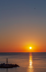 Dawn over the sea, a wonderful sun rises over the horizon.