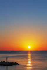 Dawn over the sea, a wonderful sun rises over the horizon.