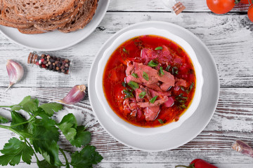 Borscht soup with meat in a white bowl. Ukrainian cuisine meal