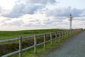 Faro de cabo Ajo con bonito cielo con nubes en Cantabria, España.