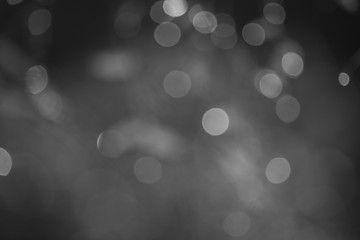 Abstract background white bokeh dispersion on a black background  
