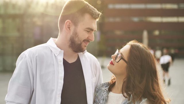 Smiling couple in love outdoors. Young happy couple hugging on the city street.