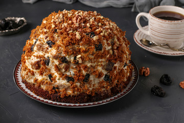 Pancho Cake with Sour Cream, Walnuts, Prunes and Chocolate on dark background