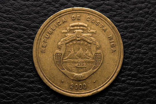 Costa Rican colones coin on black leather