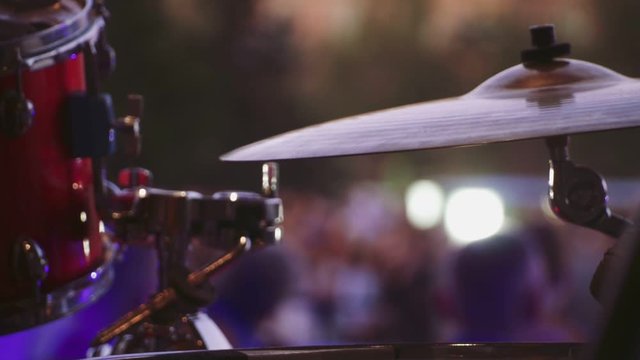 Close-up of the hands of the musician, sticks typing rhythm on the drums using hi-hat