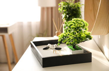 Beautiful miniature zen garden on white table indoors