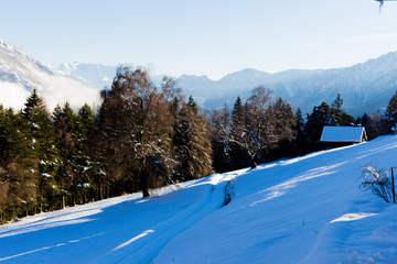 Fototapeta na wymiar Snow-covered chalet in the Swiss Alps