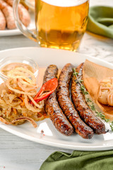 Grilled sausages with a side dish in a white plate
