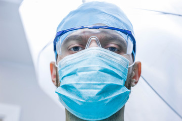 Portrait of a surgeon doctor in uniform at the medical office.
