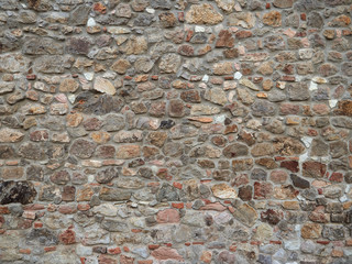 stone wall of the old town with green vines © makam1969