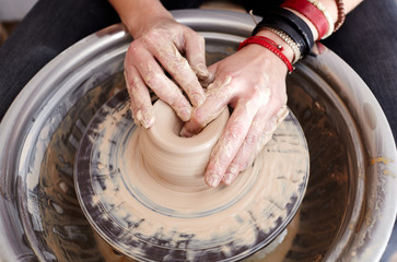 Woman's hands molding clay. Potter making ceramic pot in pottery workshop
