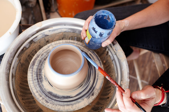 Woman's hands molding clay. Potter making ceramic pot in pottery workshop