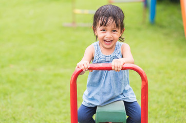 Cute asian little girl is playing in the playground funny time for kid life, concept of learning by playing.
