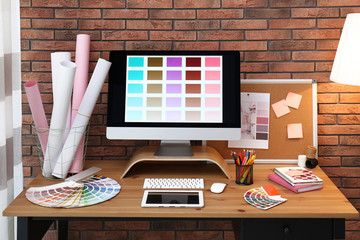 Modern computer and office supplies on wooden table. Designer's workplace
