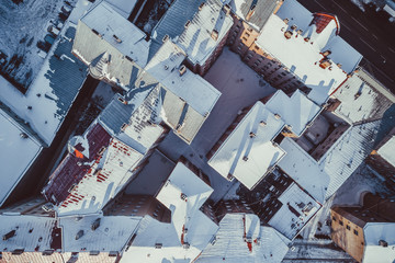 aerial view of city rooftops in winter time.