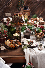 rustic style table with Christmas Eve wafer and traditional cakes
