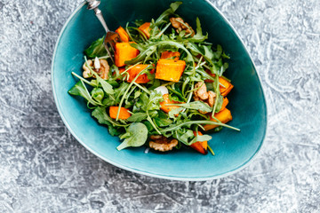 Baked pumpkin salad with rucola and nuts
