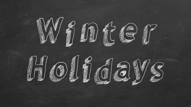 Hand drawing and animated text "Winter Holidays" on blackboard. Stop motion animation.