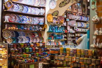 Fototapeta na wymiar Traditional Turkish ceramics on the Grand Bazaar. souvenir shop with plates, textile, cups, gift