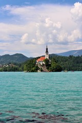 Beautiful view from shore to lake bled and its island with church.