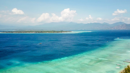 A drone shot of white sand beach on Gili Air, Lombok, Indonesia. Beautiful and clear sea water....