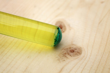 Multicomponent chemical system in test tube: a yellow aqueous solution of sodium silicate and an insoluble precipitate of blue copper silicate at the bottom of the tube.