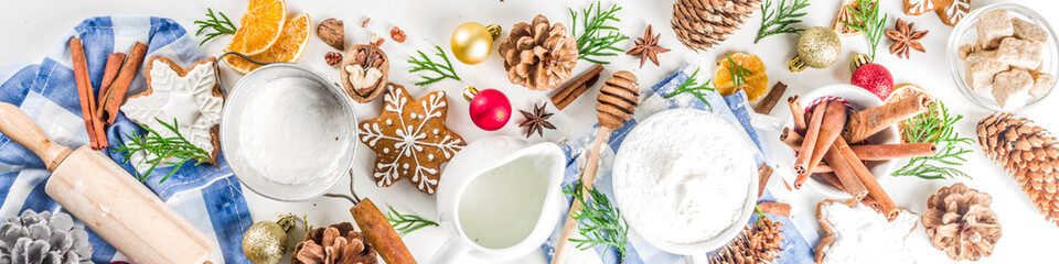 Christmas baking background. Christmas sweet cooking ingredients on white table. Ingredient for cooking christmas pastry, cookies and cakes, Flatlay on white table, top view with copy space