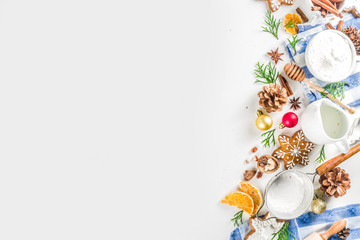 Christmas baking background. Christmas sweet cooking ingredients on white table. Ingredient for cooking christmas pastry, cookies and cakes, Flatlay on white table, top view with copy space