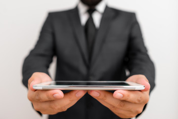 Male human wear formal work suit hold smart hi tech smartphone use hands