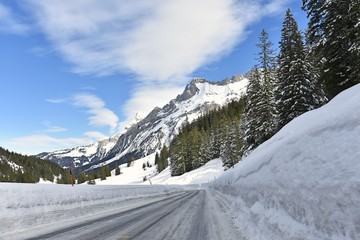 Fototapeta na wymiar winter mountain road and snow walls