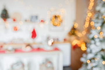 Beautiful holiday decorated kitchen with Christmas tree and bright lights , out of focus shot for photo background