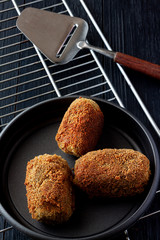 HOME CROQUETTES ON OVEN TRAY AND SPOON. SPANISH TYPICAL FOOD