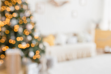 Beautiful holiday decorated room with Christmas tree and bright lights , out of focus shot for...