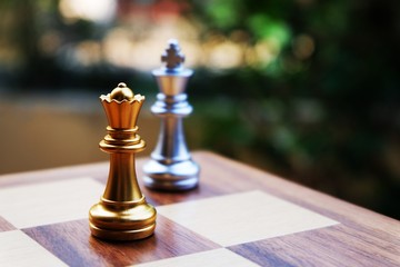 Chess board king. Queen stand against the king. Focus on Queen. Business planning and strategic concept.