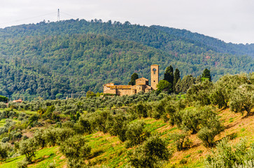 Fototapeta na wymiar View of Ss. Mary and Leonard parsih church in Artimino with typical tuscan landscape