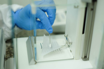 Weighing sample on the micro balance for sample solution preparation, chemical analysis of...