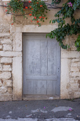 Rustic wooden door in ancient stone wall