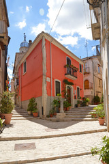 Fototapeta na wymiar Sepino, Italy, 08/14/2017. A small street among the colorful houses of a village in the Molise region