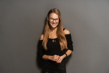 Elegant smiling woman in eyeglasses on black background