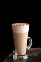 latte in a glass on a black background