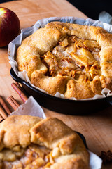 Food concept fresh baked golden Homemade Organic Apple Galette pie buttery crust in iron skillet pan with copy space