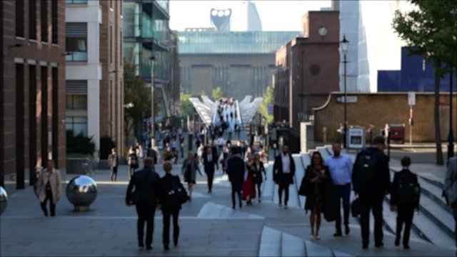 Slow motion shot of a busy footbridge Timelaspse of people walking across London Millenium bridge