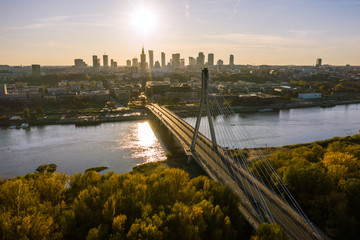Aerial view of a beautiful cityscape with bridges, a river, and a sports stadium against the backdrop of sunrise. Warsaw, Poland. 