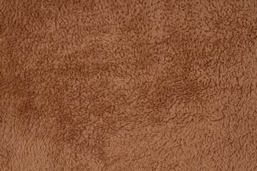 Brown sherpa textured plush fabric material background